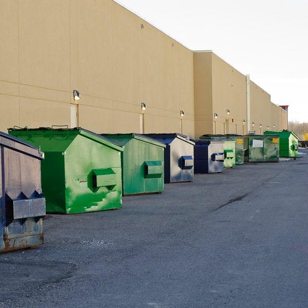 full commercial dumpster at a business complex